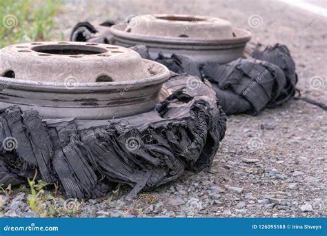Destroyed Blown Tire With Crushed And Damaged Rubber On A Truck Stock