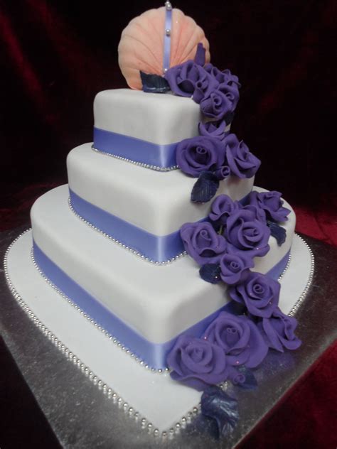 3 Tier Heart Shaped Wedding Cake With Roses And Clam Shell Cake Topper