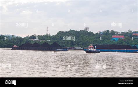 Tugboat With Barge Full Of Coal Cruising Mahakam River Samarinda