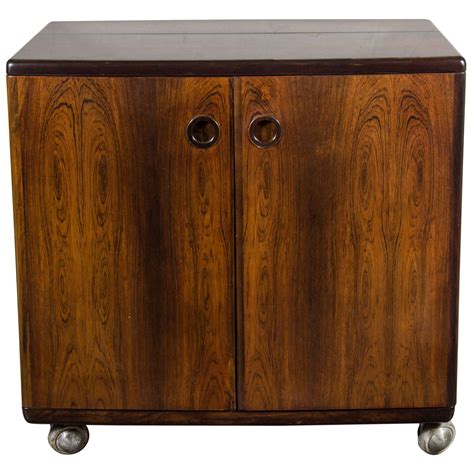 This is a 1 door wall cabinet that is hinged on top. Mid-Century Modernist Bookmatched Rosewood Flip-Top Bar ...