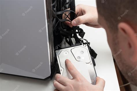 Premium Photo Computer Repair A Man Connects A Hard Drive In The