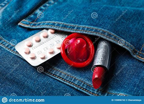 Red Lipstick With Condom And Birth Control Pills In Pocket