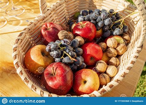 Autumn Fruits In A Basket Fresh Apples Nuts And Grapes In Autumn