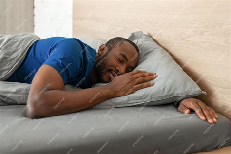 Premium Photo Black Guy Sleeping Peacefully Lying In Bed In Modern