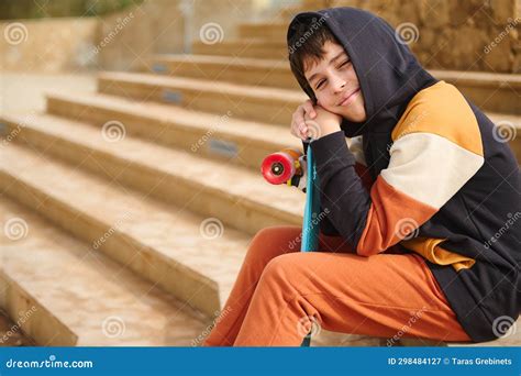 Confident Authentic Side Portrait Of Handsome Teenage Boy Sitting With