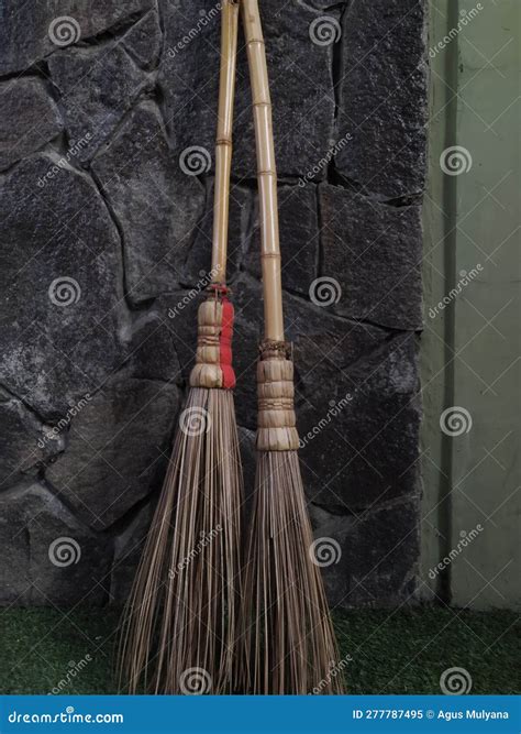 Two Stick Brooms Leaning Against The Wall Stock Image Image Of Broom