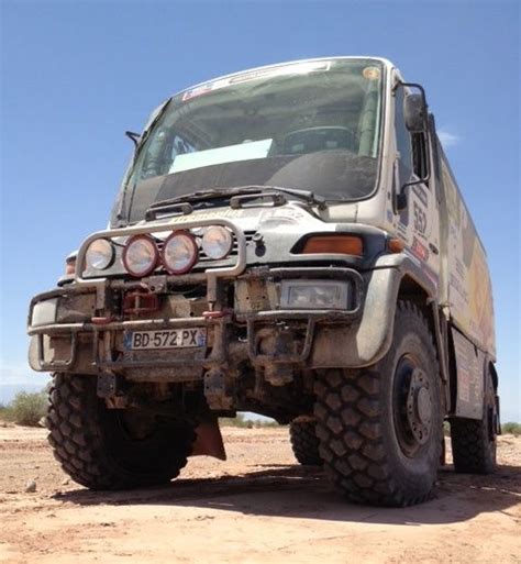 An Off Road Vehicle Parked In The Desert With Its Lights On And No
