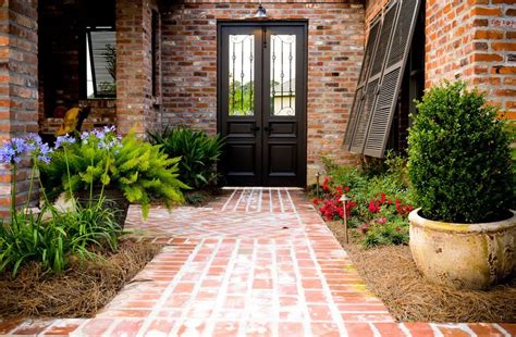 Dark red bricks set in a sandy base create the impression of age. Brick Walkway Ideas - Landscaping Network