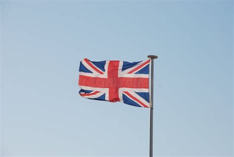 Union Jack British Flag Flying On A Weathered Flag Pole Stock Photo