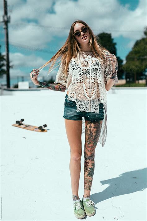 Young Tattooed Girl Skate Boarding Around Town By Stocksy
