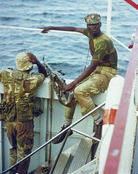 Two Soldiers Of The Rhodesian African Rifles Aboard A Patrol Boat On