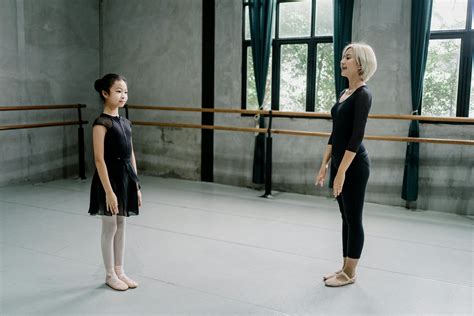 Ballerina instructor and girl trainee standing in studio · Free Stock Photo