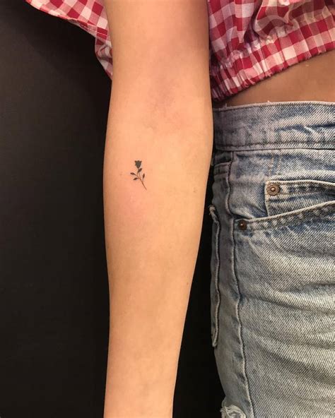 Tiny Black Rose Tattoo On The Right Inner Forearm