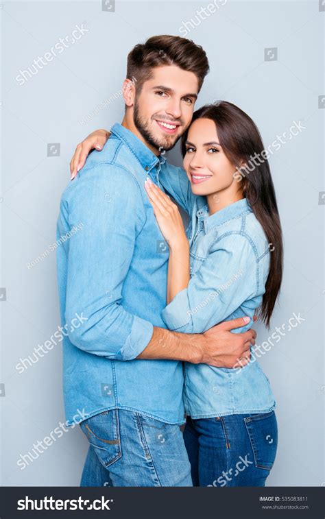 Portrait Of Young Handsome Man Embracing His Pretty Girlfriend Stock