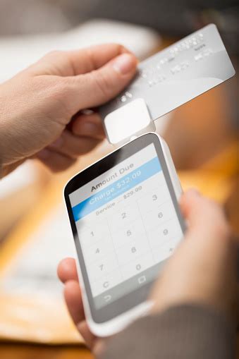 Use your phone and merchant account to accept your customer's credit cards. Cell Phone Credit Card Reader Stock Photo - Download Image Now - iStock