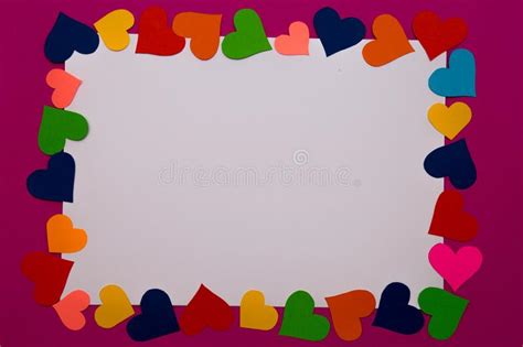 White Blank Of Paper With Border Of Multicolored Hearts Around On Pink