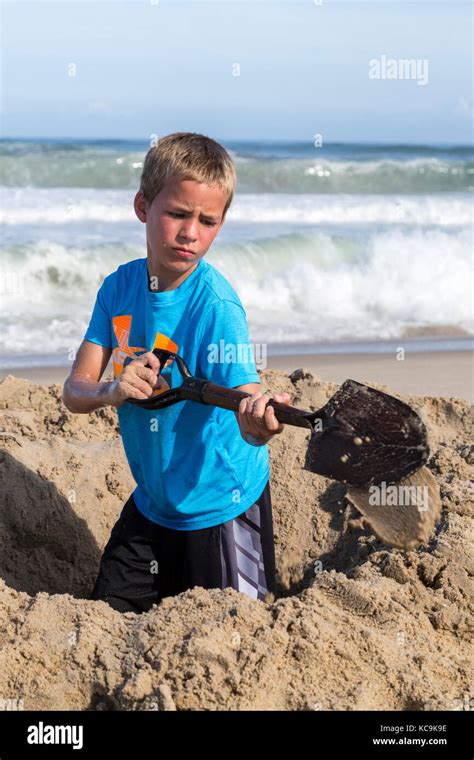 Young Boy Digging In Sand Hi Res Stock Photography And Images Alamy