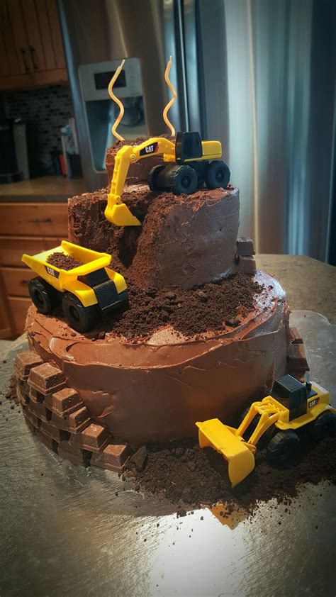 The most common 2 year old cake material is paper. Construction cake for a little boys birthday. Mini Kit Kat "bricks". #constructioncake #dirtcake ...