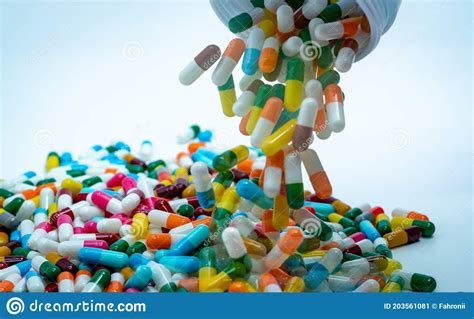 Pouring Multi Colored Capsule Pills From Plastic Drug Bottle