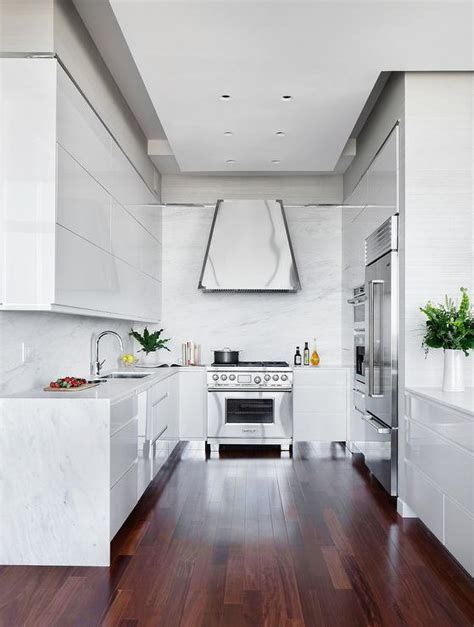 Painting your kitchen cabinets is the single most transformative thing you can do to your kitchen without a gut renovation. Glossy White lacquer cabinets with White Quartz Waterfall ...