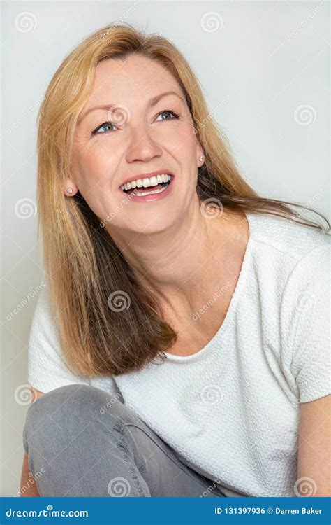Studio Portrait Of An Attractive Happy Middle Aged Blond Woman In Her Forties Stock Photo