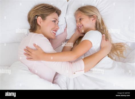 Mother And Daughter Cuddling In Bed Stock Photo Alamy