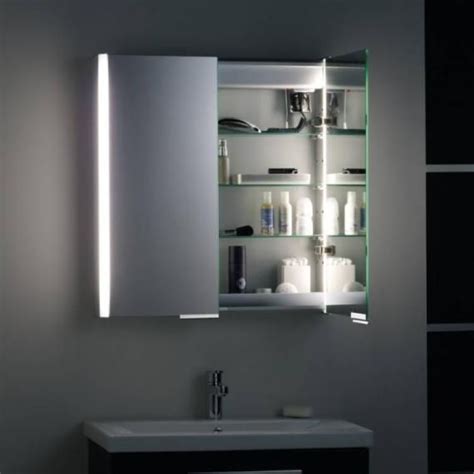 A Bathroom Sink Sitting Under A Mirror Next To A Wall Mounted Cabinet