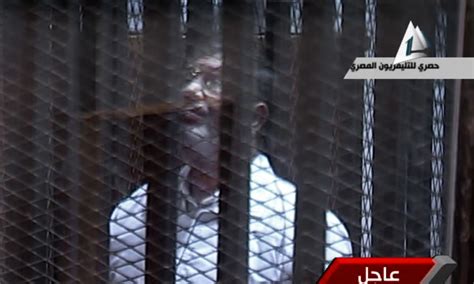 egypt s ousted president locked in glass encased cage defiant at start of prison break trial