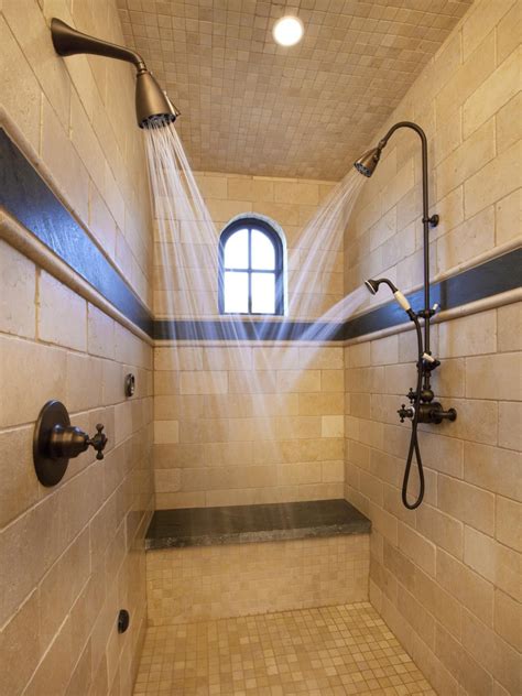 The Shower Head Is Connected To Two Faucets In This Bathroom With Tiled