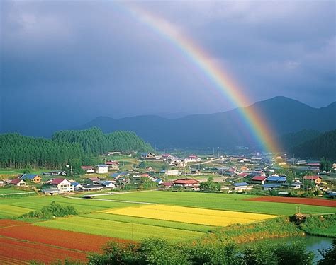 A Rainbow Is Shown Over A Town With Houses Background Autumn Season