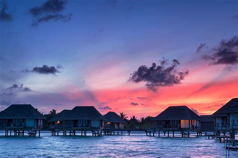 gili lankanfushi maldives coast evening tropics bungalow palms table chairs beach hd