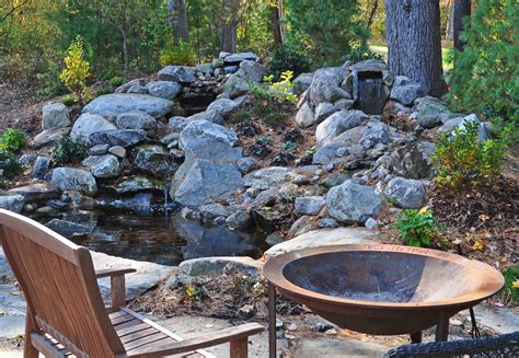 Double Rock Waterfall Into Pond With Natural Granite Patio Rock