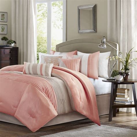 Coral bedding next to dresser as nightstand alongside blue and tan and built in cabinets. 7pc Coral & Taupe Striped Comforter Set AND Decorative ...
