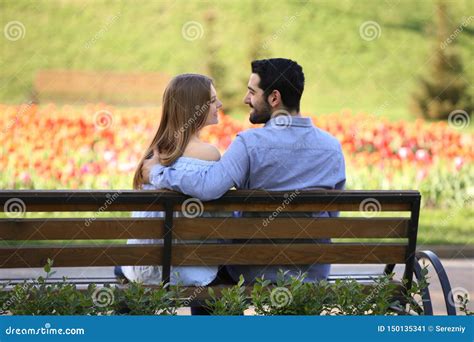 Happy Young Couple Sitting On Bench In Park Stock Image Image Of