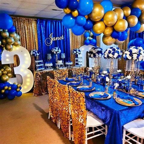 A Blue And Gold Birthday Party With Balloons Streamers Table Cloths And Decorations