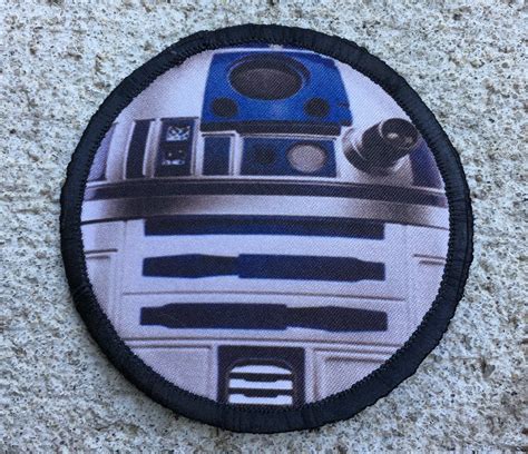 A Star Wars R2d2 Badge On The Ground
