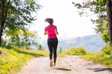 Young Woman Jogging On Sunny Day At Nature Stock Image Image Of