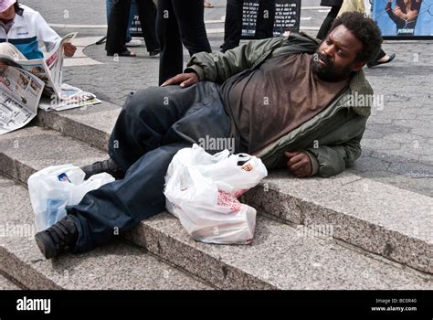 Homeless Black Man In Dirty Clothing Relaxes Peacefully Sunwarmed By