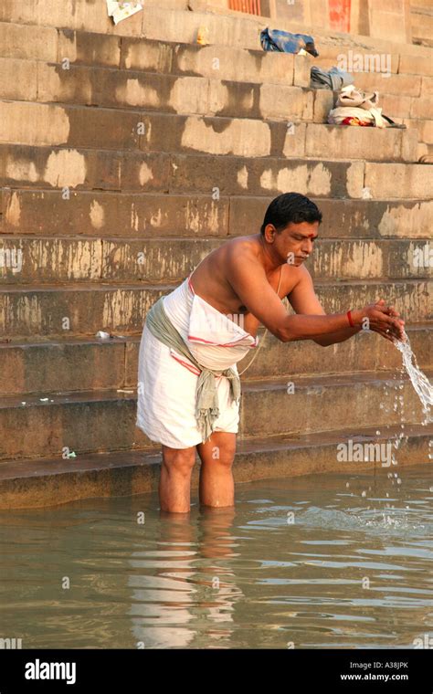 pilgrim praying in the early morning on the bank of the river ganges varanasi uttar pradesh