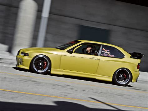 Front bumper extension, rear bumper extensions, side skirts, front and rear wheel arch extensions, rear wing. 1996 BMW 318ti Widebody Turbo - Eurotuner Magazine