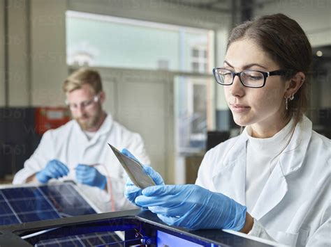 Two Technicians Working On Solar Cell In Lab Stock Photo