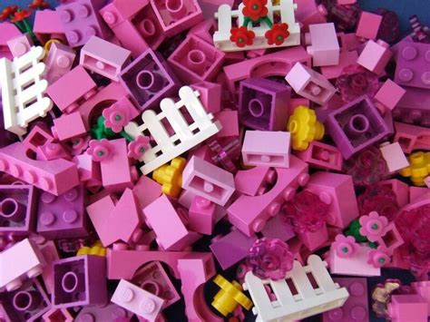 A Pile Of Pink And Yellow Legos Sitting Next To Each Other