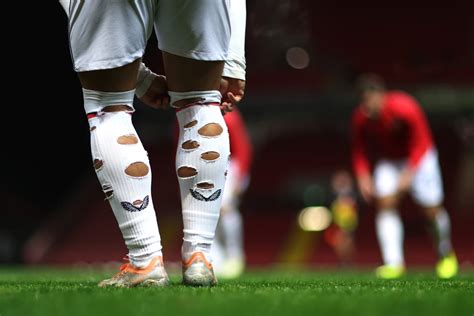 why do footballers have holes in their socks reason explained