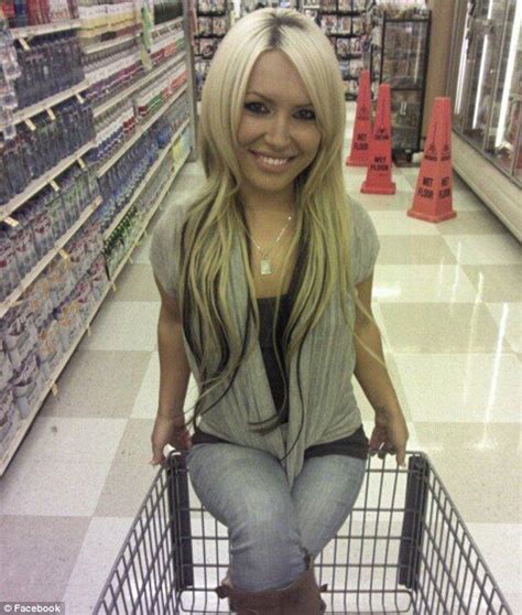 A Woman Sitting On Top Of A Shopping Cart In A Store