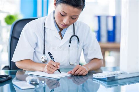 Concentrated Doctor Writing On Notebook Stock Photo Image Of Chinese