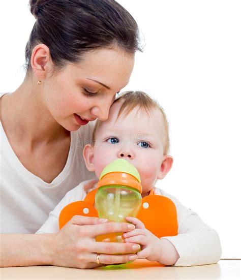 Young Mother Giving Drink To Baby From Feeding Cup Stock Image Image