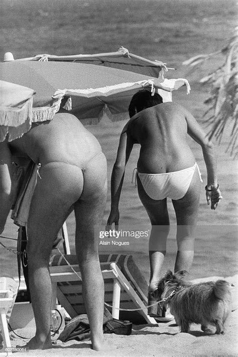 A Partially Nude Couple Sunbathes On A St Tropez Beach The Man On