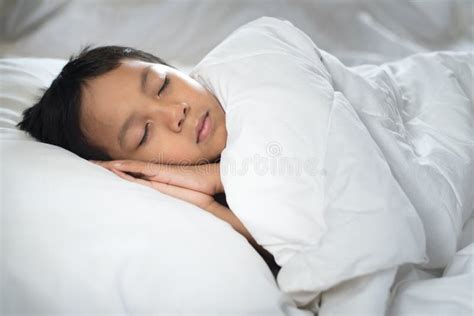 Boy Sleeping On Bed With White Sheet And Pillow Stock Photo Image Of