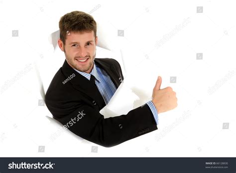 Attractive Caucasian Young Businessman Breaking Through A Paper Wall