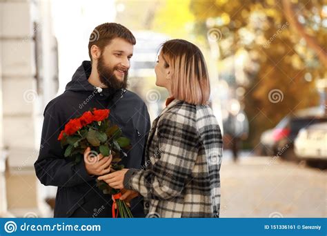 Man Giving Flowers To His Girlfriend During Romantic Date Outdoors Stock Image Image Of